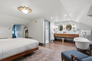 a bedroom with a large bed and a bathroom at The Gas Lamp Hotel in Philadelphia
