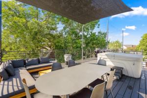 a patio with a table and chairs and a boat at Blueberry Container at EADO Juicebox in Houston