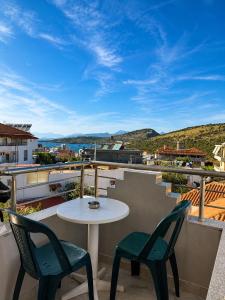 a table and chairs on a balcony with a view at Vila New Ksamil in Ksamil
