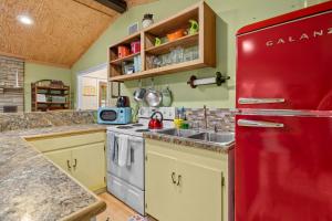a kitchen with a red refrigerator and a sink at Cozy waterfront cabin with fire pit in Old Hickory +35 photos