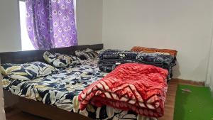 a bedroom with a bed covered in blankets at Jhalaram house in Kedārnāth