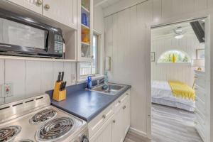a small kitchen with a sink and a microwave at The Surfcomber Unit 1 in Ocean Bay Park