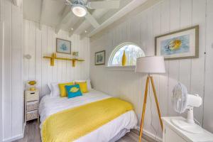 a bedroom with a bed with a yellow blanket at The Surfcomber Unit 1 in Ocean Bay Park +8 photos