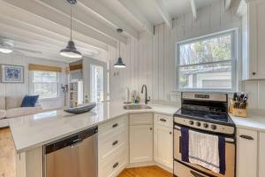 a kitchen with white cabinets and a stove top oven at The Surfcomber Unit 3 in Ocean Bay Park