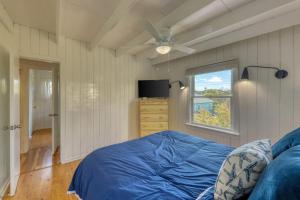 a bedroom with a blue bed and a window at The Surfcomber Unit 3 in Ocean Bay Park +7 photos