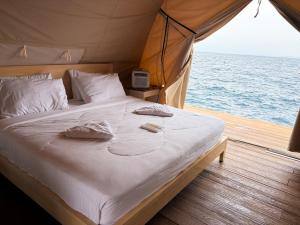 a bed in a tent on a boat at Reef Resort - Mount Apo View Unit B2 in Kaputian