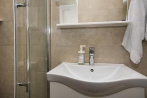 a bathroom with a sink and a shower at Lala in Herceg-Novi +31 photos