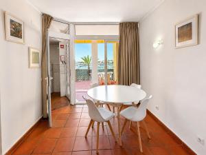 a dining room with a white table and chairs at Marina Plaza by Garvetur in Vilamoura
