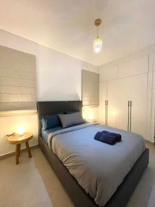 a bedroom with a large bed and a table at Beachfront Paradise - Huge Pool, Ocean View & Surf in Cabarete +14 photos