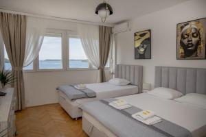 a hotel room with two beds and a window at Lala in Herceg-Novi