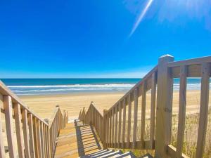 a wooden staircase leading to a beach with the ocean at 1227 - Seven Shells in Corolla