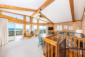 a living room with a view of the ocean at 1227 - Seven Shells in Corolla +36 photos