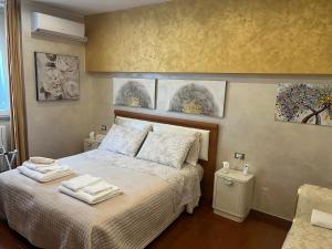 a bedroom with a bed with two towels on it at I Tre Oleandri Varenna in Varenna