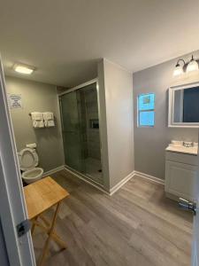 a bathroom with a shower and a toilet and a sink at The Beacon in Salter Path +47 photos