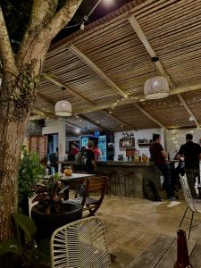 a restaurant with people sitting at tables and a bar at Hostal Juan Palitos in Los Santos
