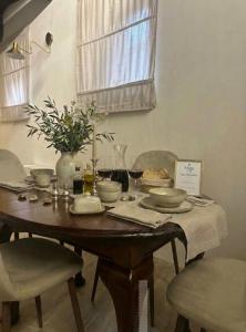 a wooden table with bowls and plates on top of it at Vega Suite in Bracciano