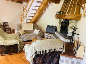 a living room with two chairs and a fireplace at Chalet individuel à Ustou 09 in Ustou