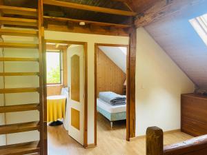 a attic room with a bed and a staircase at Chalet individuel à Ustou 09 in Ustou