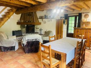 a dining room with a table and a fireplace at Chalet individuel à Ustou 09 in Ustou