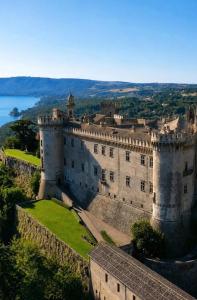 an image of a castle with the ocean behind it at Vega Suite in Bracciano