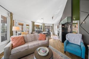 a living room with a couch and two chairs at Round House in Beech Mountain