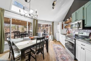 a kitchen with a table and a dining room at Round House in Beech Mountain