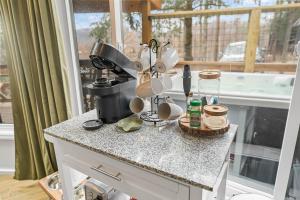 a kitchen counter with a bunch of dishes on it at Round House in Beech Mountain