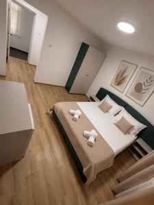 a bedroom with a large bed with towels on it at Hostel Oltenia in Eforie Sud