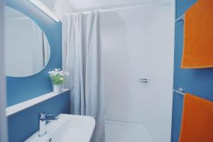 a bathroom with a white sink and a mirror at Traumhafte 2,5-Zi-Wohnung -B- mit Sicht auf See und Berge in Alpnach