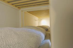 a view of a bedroom with a bed and a mirror at Traumhafte 2,5-Zi-Wohnung -B- mit Sicht auf See und Berge in Alpnach