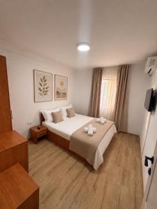 a bedroom with a large bed in a room at Hostel Oltenia in Eforie Sud