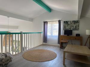 a living room with a table and a balcony at Camping les Lauriers Roses in Fréjus