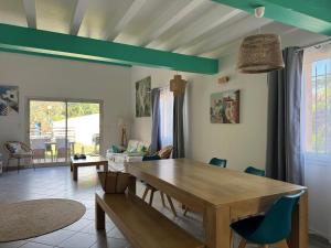 a dining room with a wooden table and chairs at Camping les Lauriers Roses in Fréjus