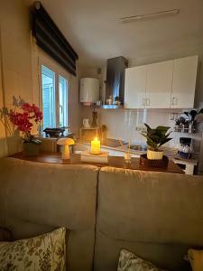 a kitchen with a table with a candle on it at Oasis de Málaga in Chilches +11 photos