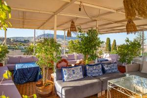 a living room with a couch and potted plants at Riad Iline fes in Fez