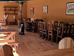 a dining room with wooden tables and chairs at Rio Cabañas in Huerta Grande