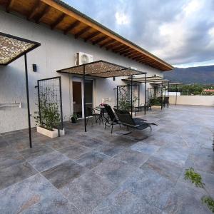 a patio with chairs and a table on a building at TERRAZA TERRAZA Merlo Apartments in Merlo