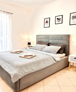 a bedroom with a bed with two towels on it at Zen Suite in Umag