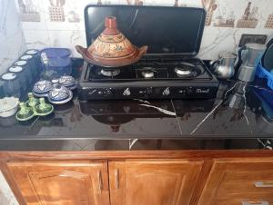a stove with a tea pot on top of it at Dar Salima in Chefchaouen