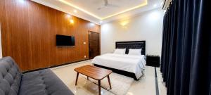 a hotel room with a bed and a couch at Divon B&B in Islamabad +15 photos
