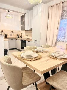 a kitchen with a wooden table and chairs at Zen Suite in Umag