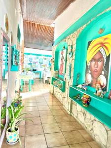 a room with a painting of a woman on the wall at Pousada Brasil Natal in Natal
