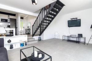 a living room with a staircase and a tv at House Nika in Punat