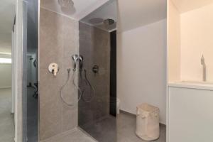 a bathroom with a shower with a glass door at House Nika in Punat +39 photos