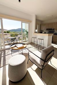a living room with a table and chairs at PH Palash Tower in Rousseau