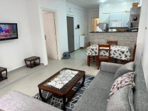a living room with a couch and a table at Appartement in Jijel