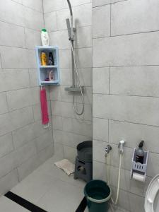 a bathroom with a shower with a toilet and a sink at Appartement in Jijel