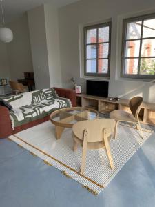 a living room with two chairs and a coffee table at Loft au château in Thonon-les-Bains
