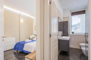 a bathroom with a bed and a sink and a toilet at Crescent Luxury Retreat - Seafront Apartment Scala E in Salerno +39 photos