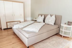a couch with pillows on it in a living room at Ferienwohnung Düring in Loxstedt
